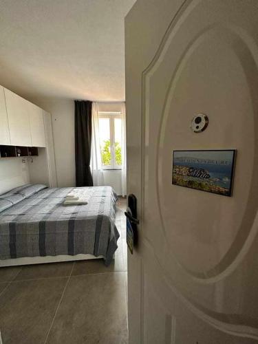 a door leading to a bedroom with a bed at La Residenza del Re! in Palau