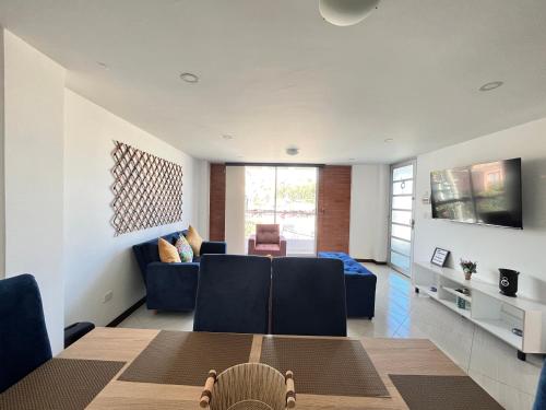 a dining room and living room with a table and chairs at Confort 301 Apartamento Duitama in Duitama