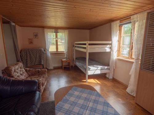 a living room with a bunk bed and a couch at Högerödja in Hultsfred
