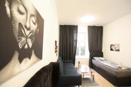 a living room with a couch and a bed at Comfort Apartment HG in Vienna