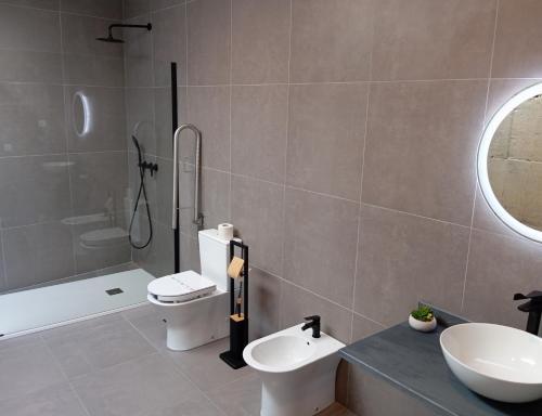 a bathroom with a sink and a toilet and a shower at Geonature in Macedo de Cavaleiros