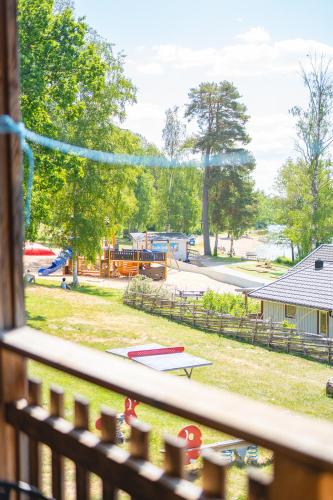 a view of a park from a balcony with a playground at Vimmerby Camping in Vimmerby
