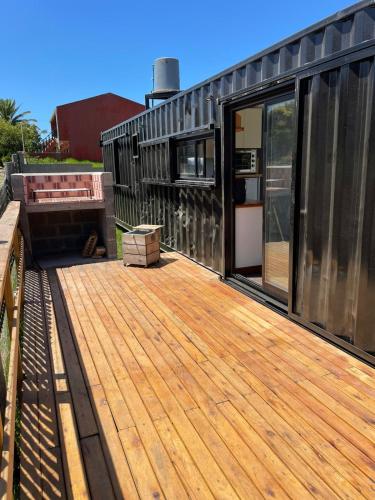 a deck on the side of a house at Apart Containers, Acantilados, unidad in Mar del Plata
