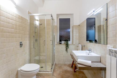 a bathroom with a toilet and a sink and a shower at Isula Relax - IsulaTravel in Modica