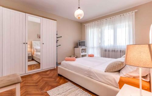 a bedroom with a large bed and a mirror at Apartments in Porec/Istrien 10281 in Poreč