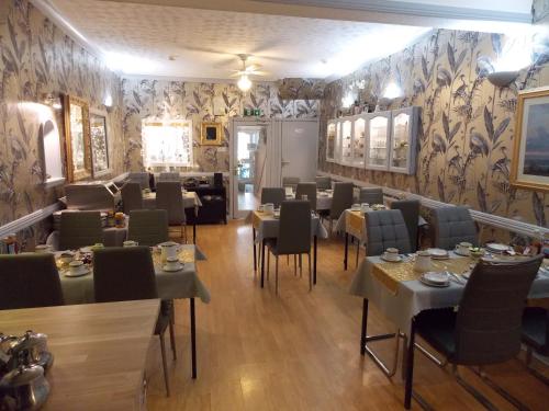 a restaurant with tables and chairs in a room at The Rockley Hotel in Blackpool