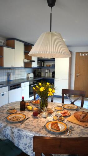 a table with plates of food on it in a kitchen at Das Neukirchen Inn in Neuburg am Inn