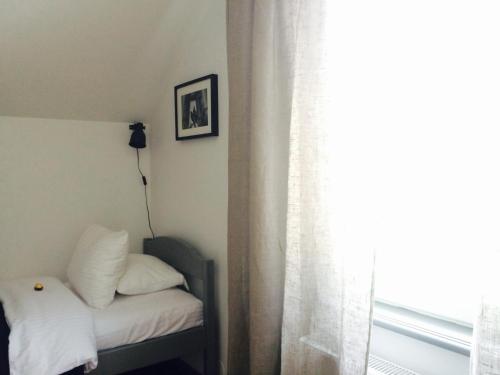a bedroom with a bed and a window at 2 Baloži in Kuldīga