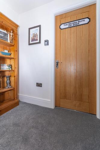 a room with a wooden door with a sign on it at The Clockhouse Bewdley in Bewdley