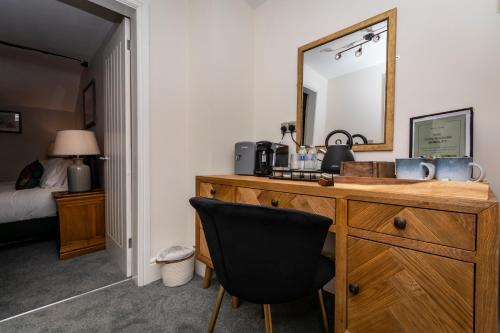 a bathroom with a wooden dresser with a mirror at The Clockhouse Bewdley in Bewdley