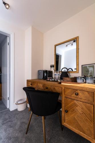 a bathroom with a wooden dresser with a mirror at The Clockhouse Bewdley in Bewdley