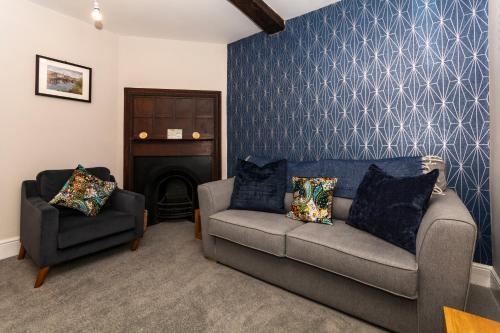 a living room with a couch and a chair at The Clockhouse Bewdley in Bewdley