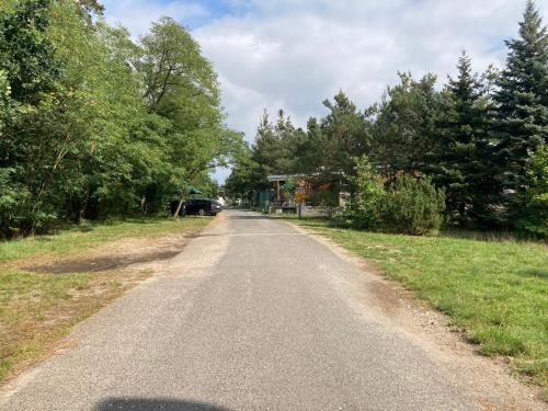 an empty road with a car parked on the side at KuK Račice in Račice