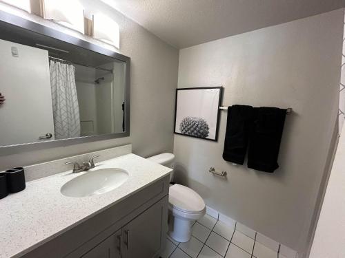 a bathroom with a sink and a toilet and a mirror at Studio 6 Sierra Vista, AZ Fort Huachuca in Sierra Vista