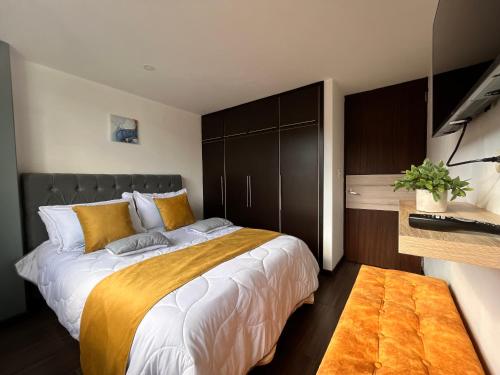 a bedroom with a large bed with a brown headboard at Confort 401 Apartamento Duitama in Duitama