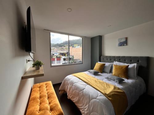a bedroom with a large bed and a window at Confort 401 Apartamento Duitama in Duitama