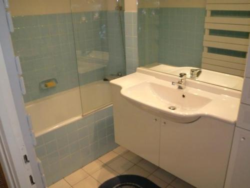 a bathroom with a sink and a shower and a tub at Appartement Huez, 2 pièces, 6 personnes - FR-1-405-194 in LʼHuez