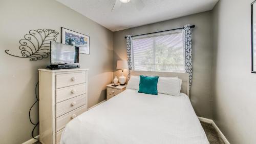 a small bedroom with a white bed and a window at Southbay 34 Beach Access 3 Bedroom Townhome in Destin