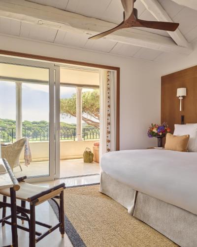 a bedroom with a large bed and a window at Airelles Château de la Messardière in Saint-Tropez