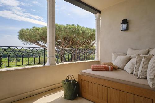 a room with a window with a bed and a view at Airelles Château de la Messardière in Saint-Tropez