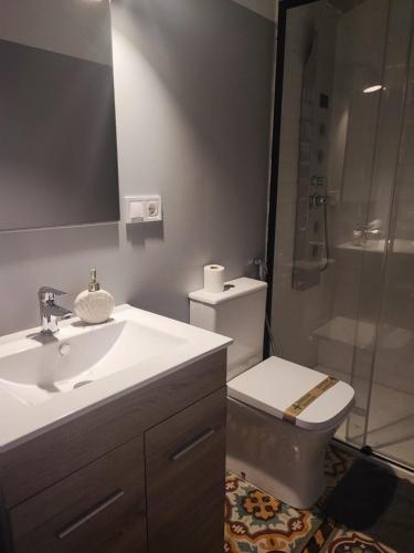 a bathroom with a toilet and a sink and a shower at Luxury 16 Imperial in Novelda