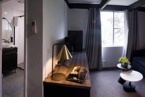 a living room with a table with a fire in it at Echo Point Discovery Motel in Katoomba