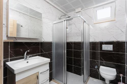 a bathroom with a shower and a sink and a toilet at Villa Azalea 1 in Ortaca
