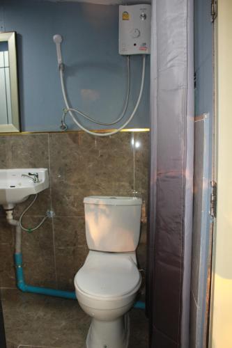 a bathroom with a white toilet and a sink at Do Dee cafe in Bangkok