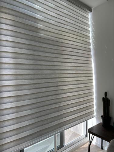 a window with a venetian blind in a room at Lovely and Peaceful Home in Guatemala