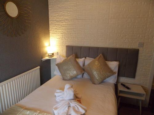a baby sitting on a bed in a room at The Rockley Hotel in Blackpool