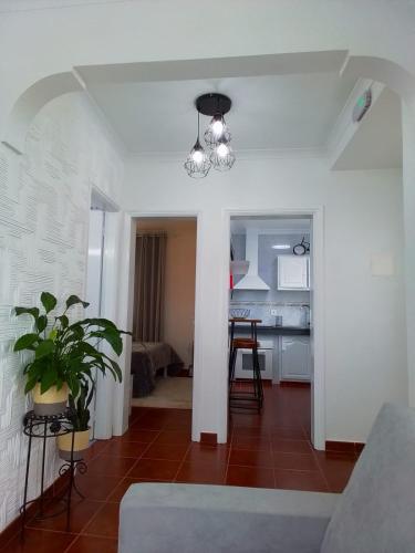 a living room with a couch and a dining room at Alojamento Bela Vista in Lajes do Pico