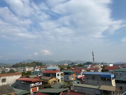 a group of buildings in a city under a cloudy sky at Minh Loan Hotel in Nước Hai