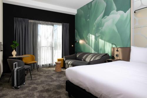 Säng eller sängar i ett rum på Otium Hotel Roosendaal