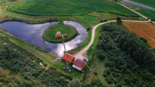 an aerial view of a house and a lake at Kundziņu salas in Vidriži