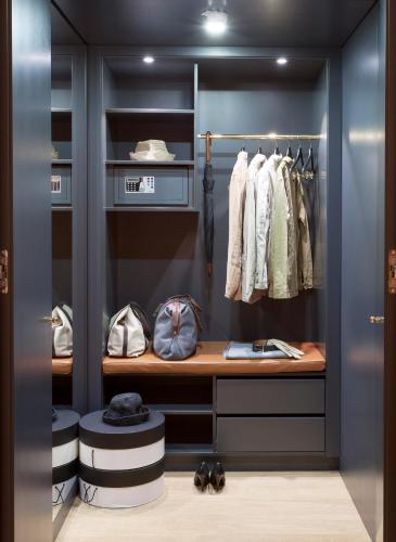 a walk in closet with blue walls and a wooden table at The Guesthouse Vienna in Vienna