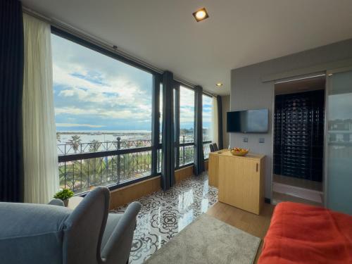 a living room with a view of the ocean at Mihman Hotel in Tuzla