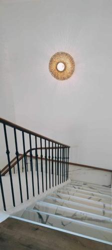 a spiral staircase with a light on the ceiling at Coco Marco Hôtel in Nyons