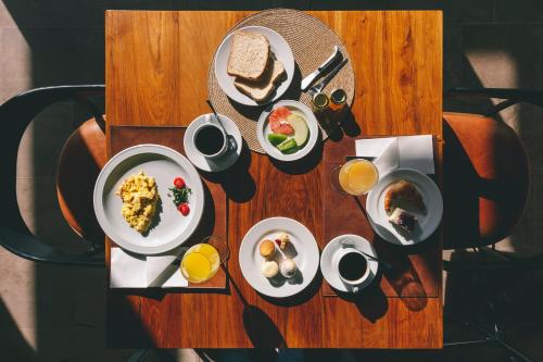a wooden table with plates of food on it at Rosell Boher Winery Lodge & Spa in Agrelo