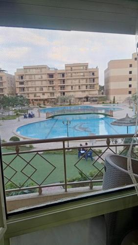 a view of a swimming pool from a window at Pyramids and Museum Resort /villa in Giza