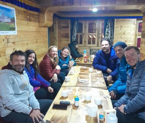 a group of people sitting around a table at Tribeni Lodge Restaurant And Bar in Phakding
