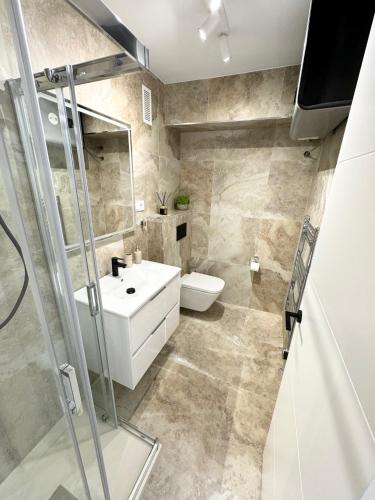a bathroom with a white sink and a toilet at Calpe Beach Apartment I Arenal Beach in Calpe