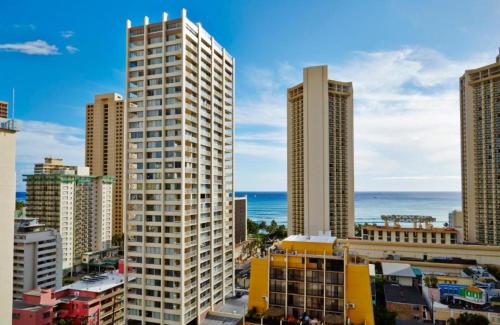 a view of a city with tall buildings and the ocean at Pacific Monarch in Honolulu