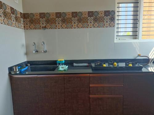 a kitchen with a sink and a counter top at CasaBonito 3BHK Villa in Mysore