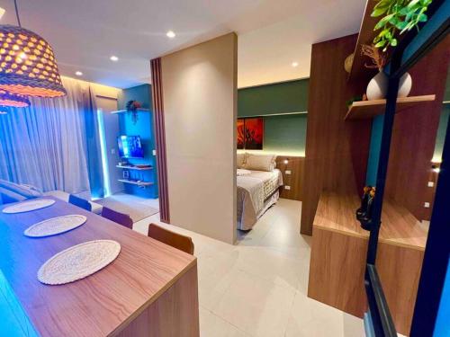 a room with a dining table and a bedroom at Novíssimo ,ótima localização. in Aracaju
