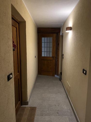 an empty hallway with a door and a window at Casa Agnes in Bardonecchia