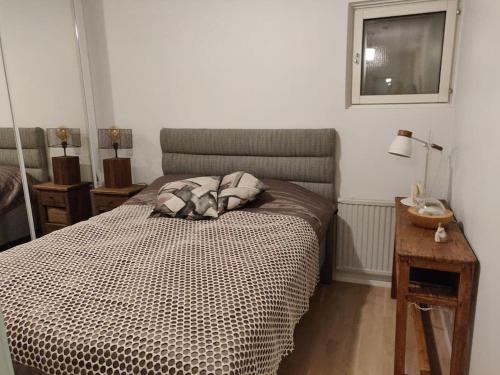 a bedroom with a bed and a table and a window at Merikorte in Naantali