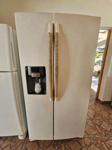 a refrigerator with a dispenser on the side of it at Sunset Surf Villa in La Libertad