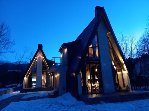 a house in the snow at night at Villa Tina in Štrpce