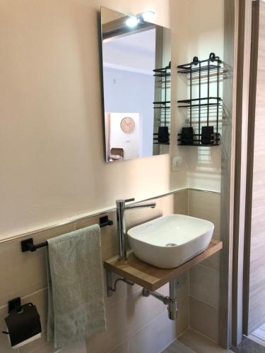 a bathroom with a sink and a mirror at Domus Alessia in Monserrato