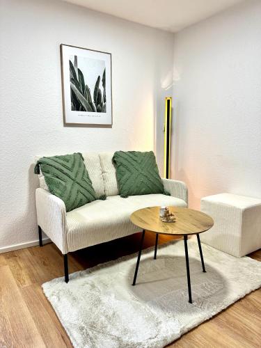 a living room with a couch and a table at Stilvolles Wohnen am Hafen in Bregenz